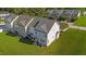 Backyard view of townhome featuring a patio, green lawn, and proximity to neighboring homes at 101 Wimbledon Ct, Clayton, NC 27520