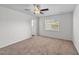 Bedroom has a lighted ceiling fan, window and neutral carpet and paint at 101 Wimbledon Ct, Clayton, NC 27520