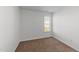 Bright bedroom features plush carpeting and a window offering natural light at 101 Wimbledon Ct, Clayton, NC 27520