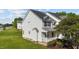 Side view of a charming two-story house featuring white siding and a well-manicured lawn at 101 Wimbledon Ct, Clayton, NC 27520