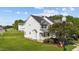 Side view of house with a well-manicured lawn surrounded by greenery and blue skies at 101 Wimbledon Ct, Clayton, NC 27520