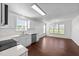 Updated kitchen with stainless steel appliances, white cabinets, and an adjacent dining area filled with light at 101 Wimbledon Ct, Clayton, NC 27520