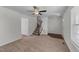 A clean and bright living room with a ceiling fan and neutral decor, showcasing a staircase at 101 Wimbledon Ct, Clayton, NC 27520