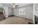 Well-lit living room featuring a fireplace, staircase and a large window for ample natural light at 101 Wimbledon Ct, Clayton, NC 27520