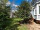 Spacious backyard featuring mature trees, a deck with stairs, and a swing set at 103 Glenstone Ln, Cary, NC 27518