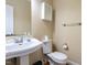 Classic half bathroom with a pedestal sink, toilet, and mirrored medicine cabinet at 103 Glenstone Ln, Cary, NC 27518