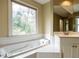 Bright bathroom with a large soaking tub and ample natural light at 103 Glenstone Ln, Cary, NC 27518