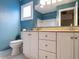 Bright bathroom with a blue wall, a toilet, and a vanity at 103 Glenstone Ln, Cary, NC 27518
