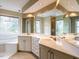 Spacious bathroom featuring double vanities, mirrors, and a soaking tub at 103 Glenstone Ln, Cary, NC 27518