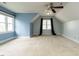 Bright attic bedroom with neutral carpet and blue paint at 103 Glenstone Ln, Cary, NC 27518
