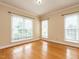 Bright bedroom featuring hardwood floors, and large windows with natural light at 103 Glenstone Ln, Cary, NC 27518