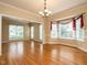 Spacious dining room features hardwood floors and plenty of natural light from the surrounding windows at 103 Glenstone Ln, Cary, NC 27518