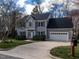 Two-story home with an attached two car garage, blue shutters, and established landscaping at 103 Glenstone Ln, Cary, NC 27518