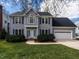 Charming two-story home featuring a manicured lawn, two car garage, and blue shutters at 103 Glenstone Ln, Cary, NC 27518