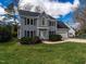 Charming two-story home featuring a two-car garage, blue shutters, and landscaped front yard at 103 Glenstone Ln, Cary, NC 27518