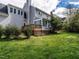 Rear exterior view of a home featuring a deck, sunroom, and well-maintained lawn at 103 Glenstone Ln, Cary, NC 27518