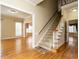 Bright foyer with hardwood floors, staircase, and views into the living room at 103 Glenstone Ln, Cary, NC 27518
