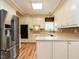 Well-lit kitchen featuring stainless steel refrigerator and appliances, and ample counter space at 103 Glenstone Ln, Cary, NC 27518