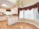 Inviting eat-in kitchen with an island, white cabinetry, and a large window for natural light at 103 Glenstone Ln, Cary, NC 27518