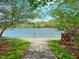 A scenic view of the lake from a walking path with trees framing the scene at 103 Glenstone Ln, Cary, NC 27518