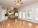 Open concept living room with hardwood floors, leads to the kitchen, and has sliding doors to the patio at 103 Glenstone Ln, Cary, NC 27518