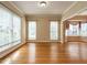 Spacious living room featuring hardwood floors, large windows, and crown molding at 103 Glenstone Ln, Cary, NC 27518