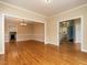 Open-concept living room featuring hardwood floors and entryways to other rooms at 103 Glenstone Ln, Cary, NC 27518