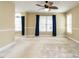 Inviting living room featuring a ceiling fan, neutral paint, and bright windows at 103 Glenstone Ln, Cary, NC 27518