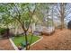 Backyard featuring a well-maintained lawn, deck, and wooded perimeter at 104 Chris Ct, Cary, NC 27511
