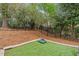 Backyard features manicured lawn, trees, and privacy fence at 104 Chris Ct, Cary, NC 27511