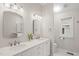 Bathroom with double sinks, white cabinets, granite countertop, and modern fixtures at 104 Chris Ct, Cary, NC 27511