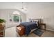 Bedroom with vaulted ceiling, large window, wood floors, and comfortable king bed at 104 Chris Ct, Cary, NC 27511