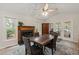 Spacious dining room with a fireplace, stylish furniture, and bright windows allowing natural light at 104 Chris Ct, Cary, NC 27511