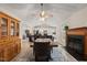 Open-concept view of the dining room with fireplace that flows into the kitchen with an island and pendant lights at 104 Chris Ct, Cary, NC 27511