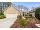 Charming single-story home featuring an attached garage and well-maintained front yard with garden beds at 104 Chris Ct, Cary, NC 27511
