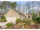 Charming single-story home featuring a two-car garage, tidy landscaping, and tan siding at 104 Chris Ct, Cary, NC 27511