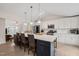 Bright, modern kitchen with stainless steel appliances, a large island, and is adjacent to the living room at 104 Chris Ct, Cary, NC 27511
