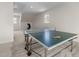 Basement game area with ping pong table, with natural light from the windows at 109 Chimeneas Pl, Chapel Hill, NC 27517