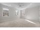 Bright bedroom with carpet, ceiling fan, and natural light from three large windows offers a serene space at 109 Chimeneas Pl, Chapel Hill, NC 27517