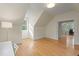 Bonus Room with hardwood floors, access to the office area, and dormer windows at 109 Chimeneas Pl, Chapel Hill, NC 27517
