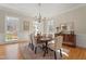Formal dining room featuring hardwood floors, lots of natural light, and elegant furnishings at 109 Chimeneas Pl, Chapel Hill, NC 27517