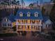 Aerial view of a stately two-story home with a full front porch at 109 Chimeneas Pl, Chapel Hill, NC 27517