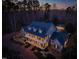 Aerial view of a large two-story house with an expansive porch and swimming pool at 109 Chimeneas Pl, Chapel Hill, NC 27517