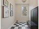 Foyer featuring black and white tiled floor, coat rack and pet themed art at 109 Chimeneas Pl, Chapel Hill, NC 27517