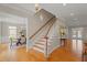 Elegant foyer with hardwood floors and a staircase, seamlessly connecting to other living spaces at 109 Chimeneas Pl, Chapel Hill, NC 27517