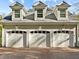 Three car garage with dormer windows and brick paver driveway at 109 Chimeneas Pl, Chapel Hill, NC 27517