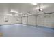 Spacious three-car garage featuring painted floors and carriage style doors at 109 Chimeneas Pl, Chapel Hill, NC 27517