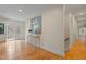 Elegant hallway with hardwood floors, crown molding, and stylish decor leading to the outdoors at 109 Chimeneas Pl, Chapel Hill, NC 27517