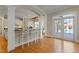 Kitchen bar with seating and views of the pool area through French doors at 109 Chimeneas Pl, Chapel Hill, NC 27517