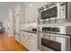 Kitchen featuring stainless steel appliances and white cabinets with black countertops at 109 Chimeneas Pl, Chapel Hill, NC 27517